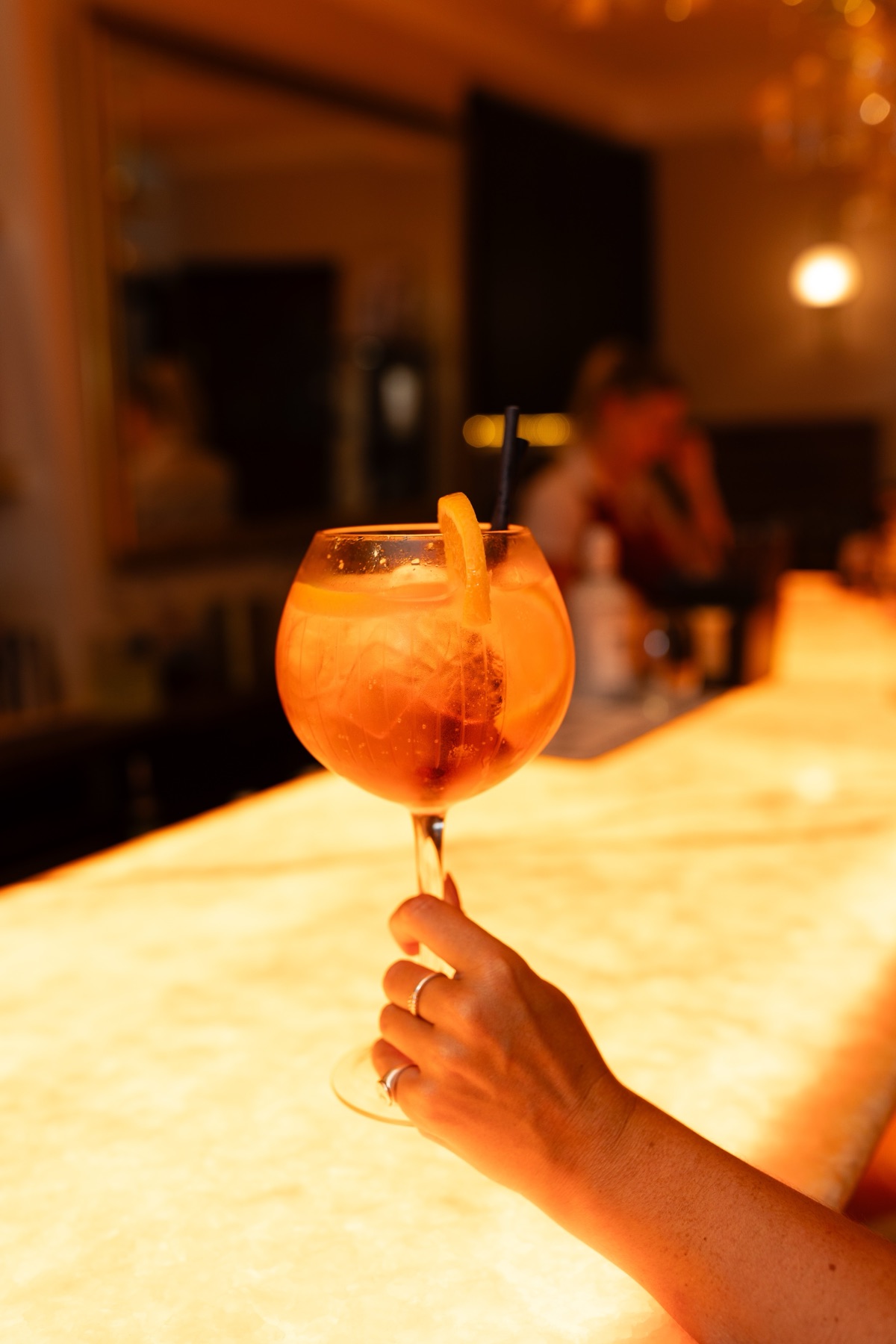A cocktail on the glowing bar at The Priory
