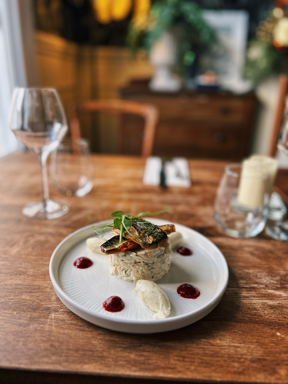 A plated fish dish with beurre blanc at The Priory